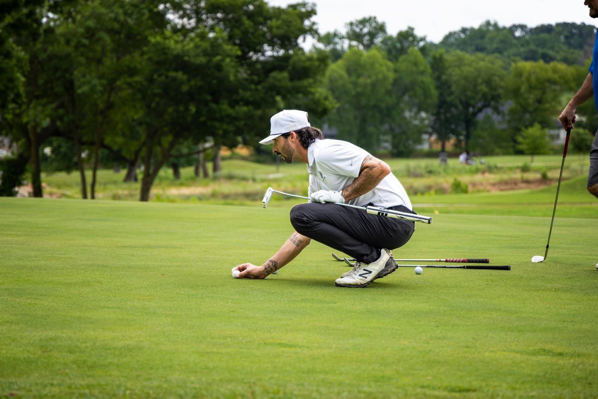 A golfer reading the line on the green