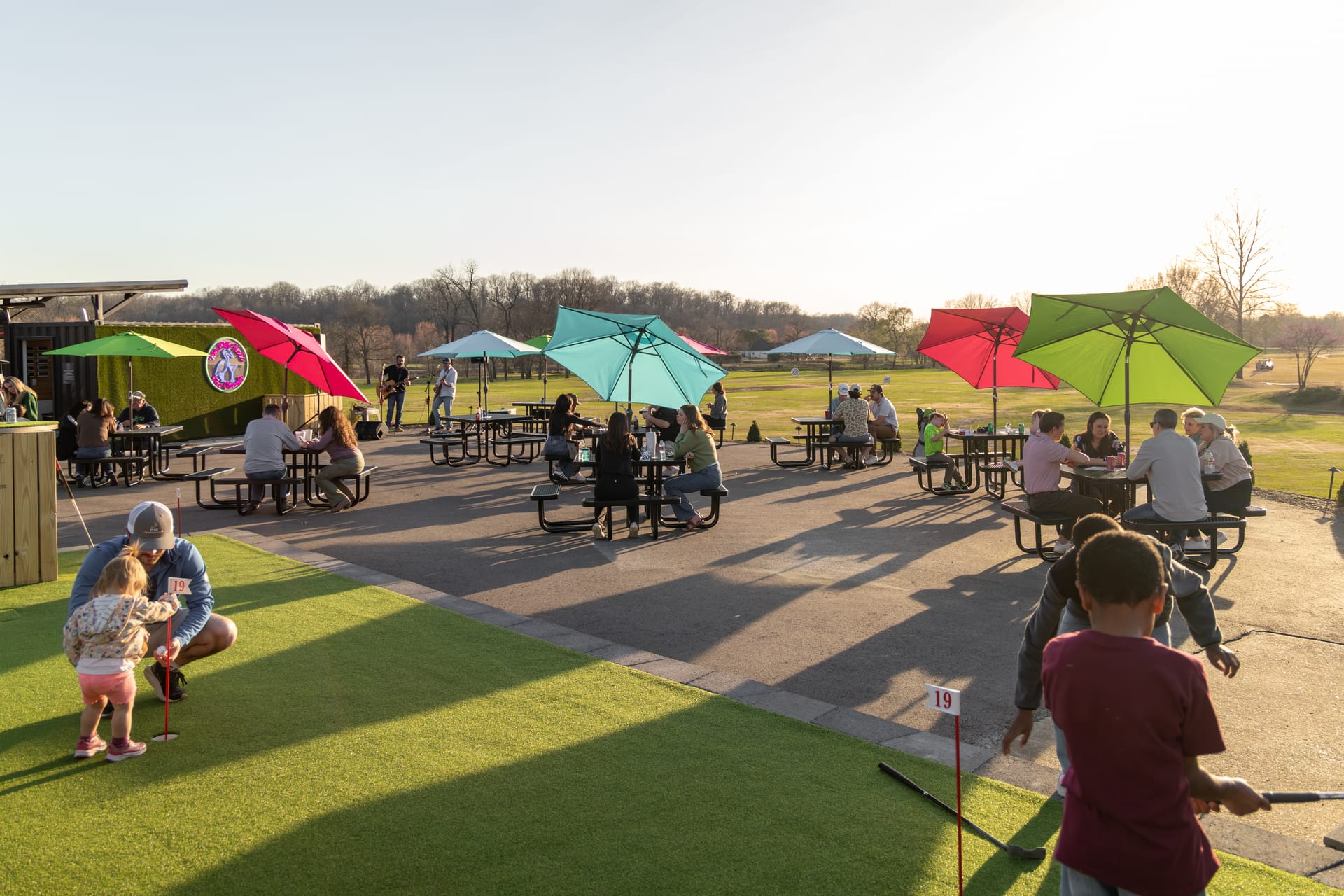 Golden-hour life at The Creeks: the patio, the music, and the course