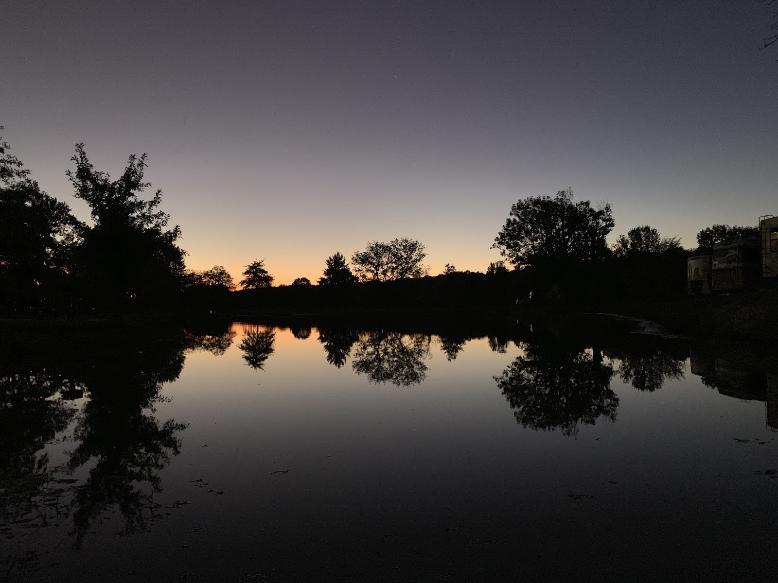 A mirror-calm pond reflecting the sky