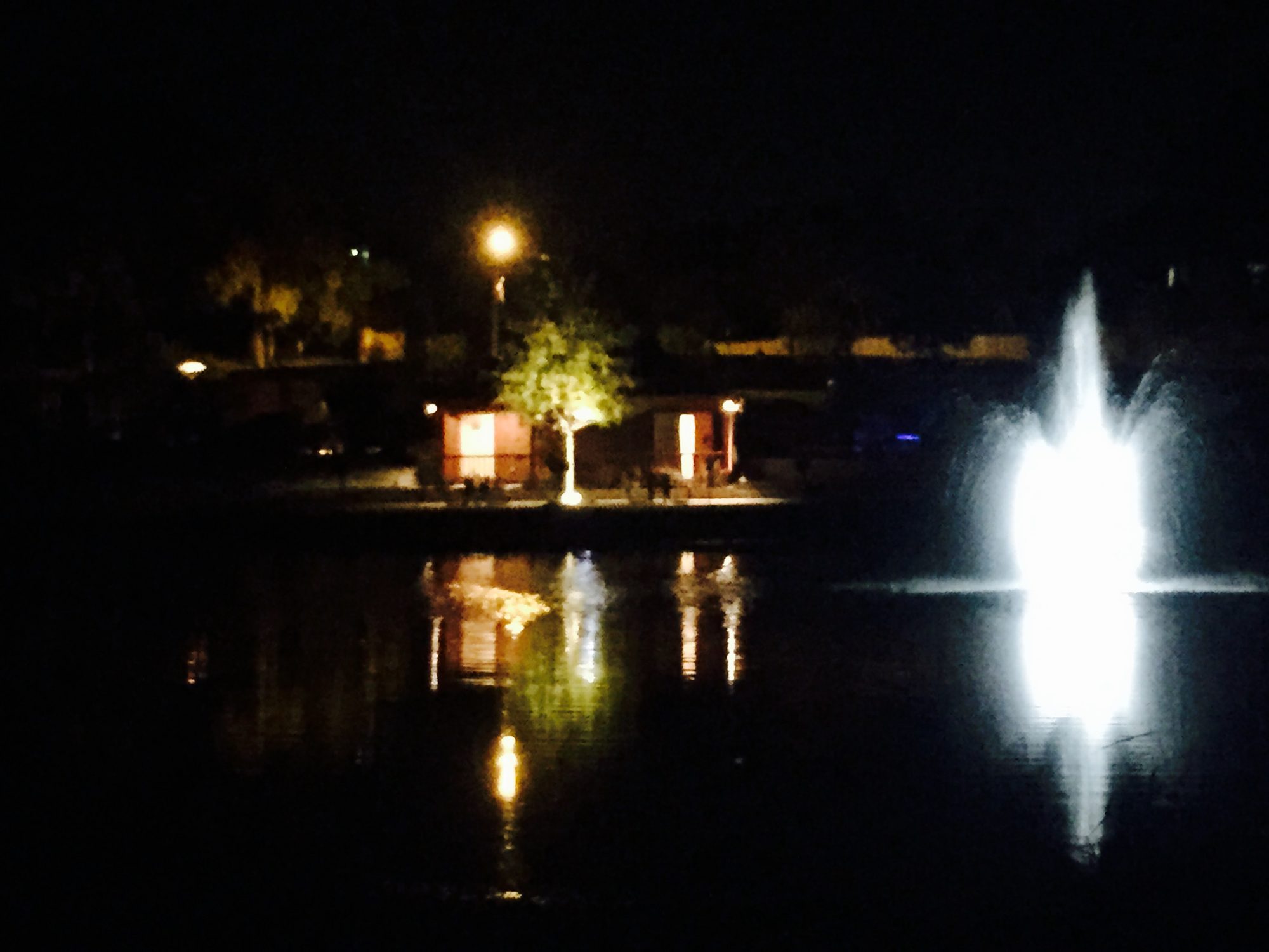 The patio at night with the fountain lit